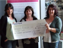Sisters Frances Murphy, far left and Brid Diver present Colette Burke, centre, with a cheque in aid of DACC.