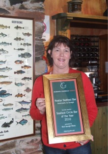 Tricia Kealy holding her Seafood Circle Seafood Bar of the Year 2010 award.