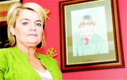 Bernie Doherty with a photo of her late son Oran in the background.